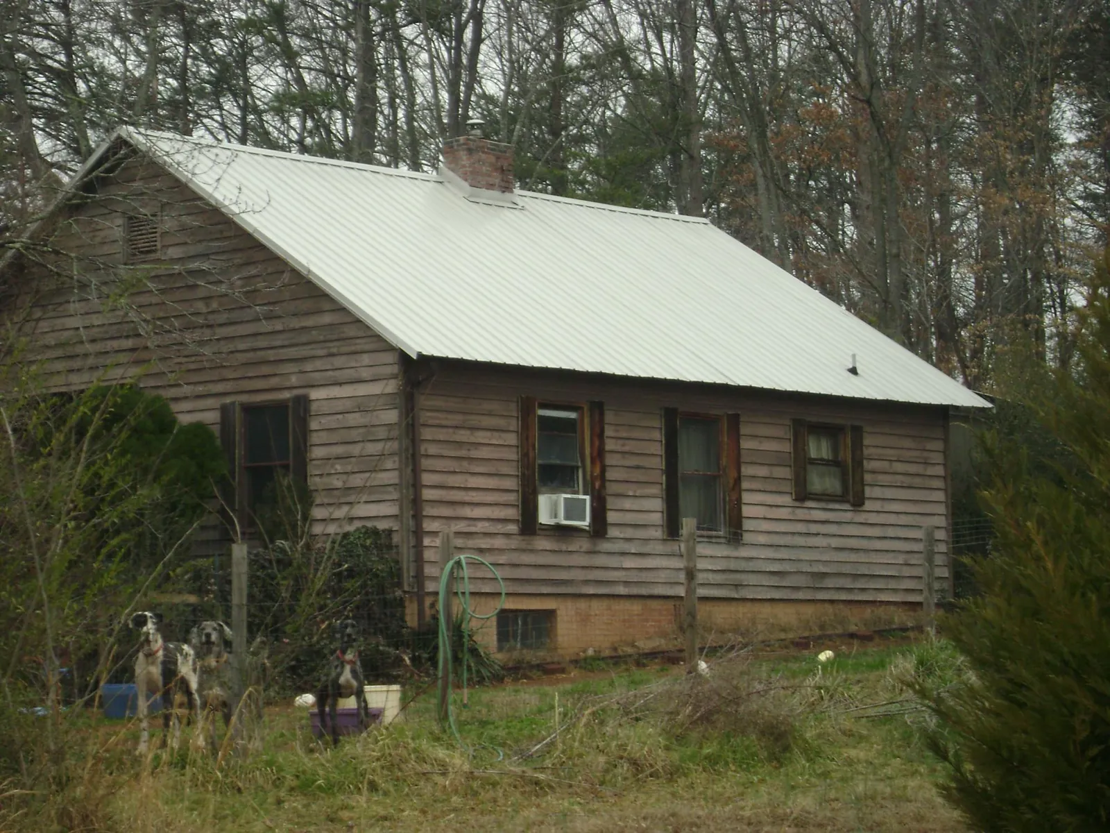 White metal roof on an old wood sided farmhouse, from a Metal Roof Installation job in Deatsville
